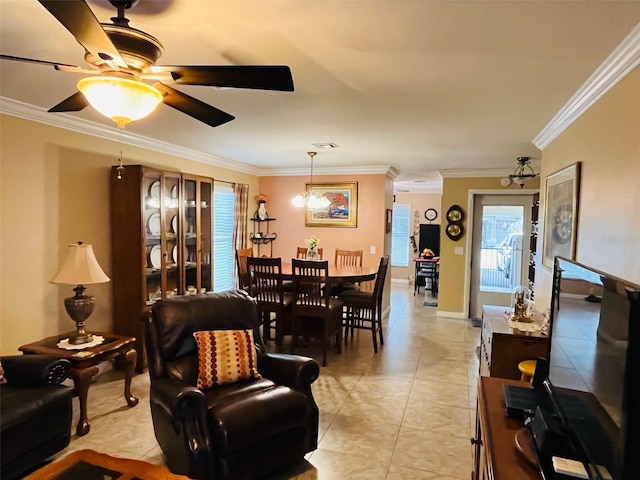 living area with visible vents, crown molding, light tile patterned floors, baseboards, and ceiling fan