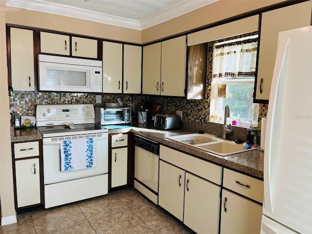 kitchen with a sink, white appliances, tasteful backsplash, and crown molding