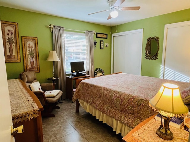 bedroom with tile patterned flooring, a closet, and a ceiling fan