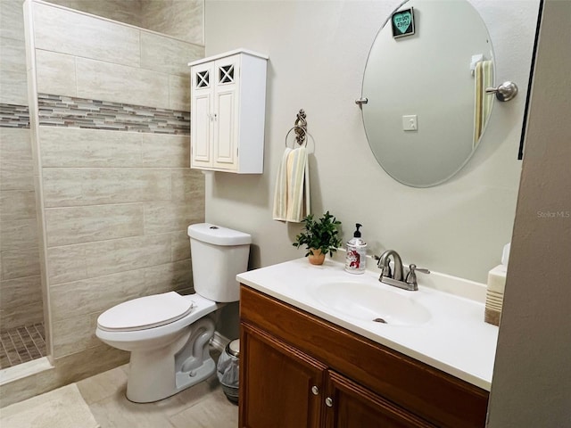 full bath featuring vanity, toilet, and a tile shower