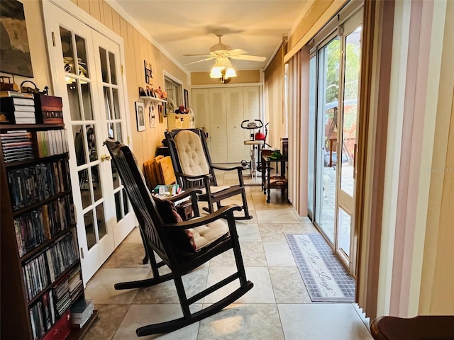 workout room with a ceiling fan, crown molding, and french doors