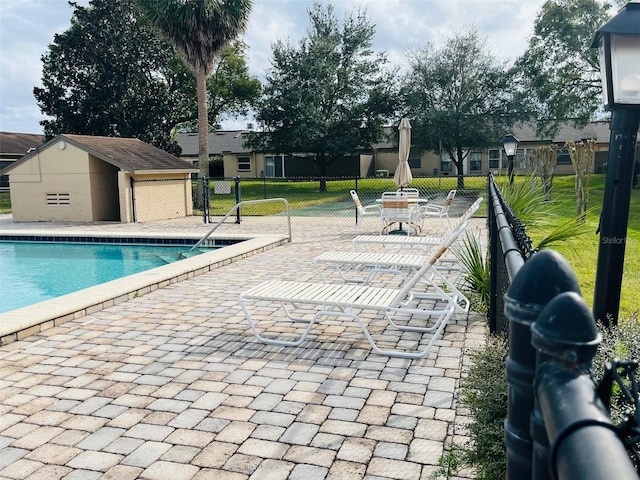 community pool featuring a patio and fence