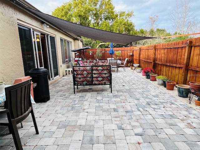 view of patio / terrace with an outdoor living space, outdoor dining area, and a fenced backyard