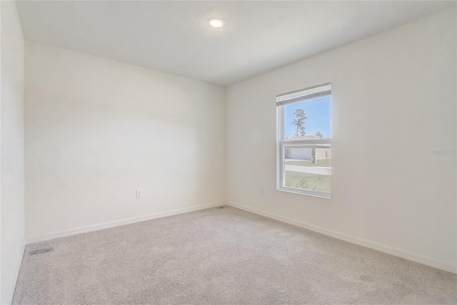 unfurnished room featuring carpet flooring and baseboards