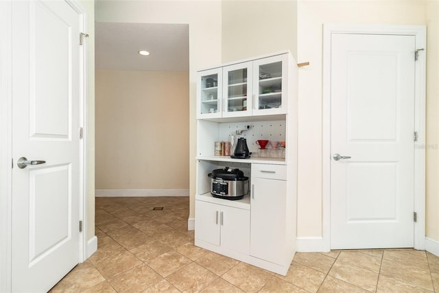 bar with light tile patterned floors and baseboards