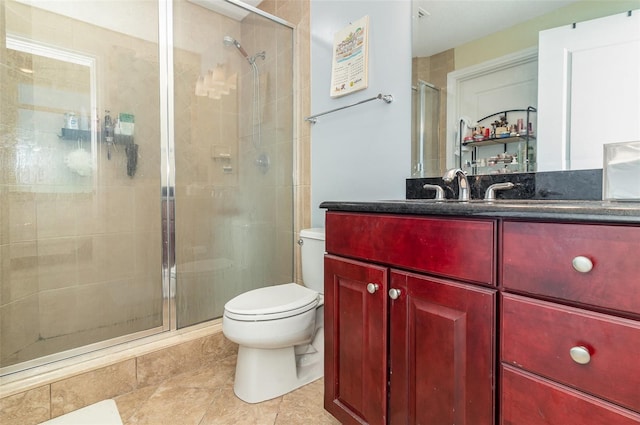 bathroom featuring toilet, a stall shower, and vanity