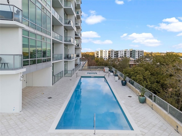 community pool with a patio area