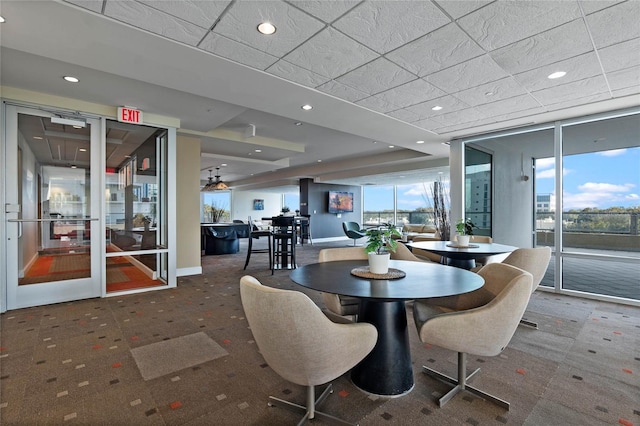 dining space featuring recessed lighting, a paneled ceiling, and baseboards