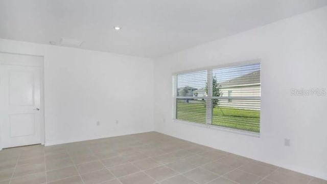 unfurnished room featuring tile patterned flooring