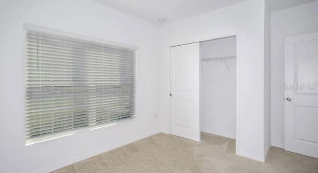 unfurnished bedroom featuring a closet and carpet floors