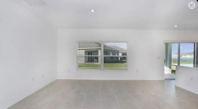 tiled spare room with recessed lighting