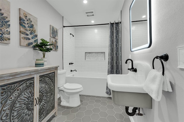 bathroom with tile patterned floors, visible vents, toilet, and shower / tub combo