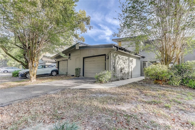 1318 Chebon Ct Unit E-F, Unit E-F, Apopka, FL 32712 - view of property exterior featuring aphalt driveway and a garage