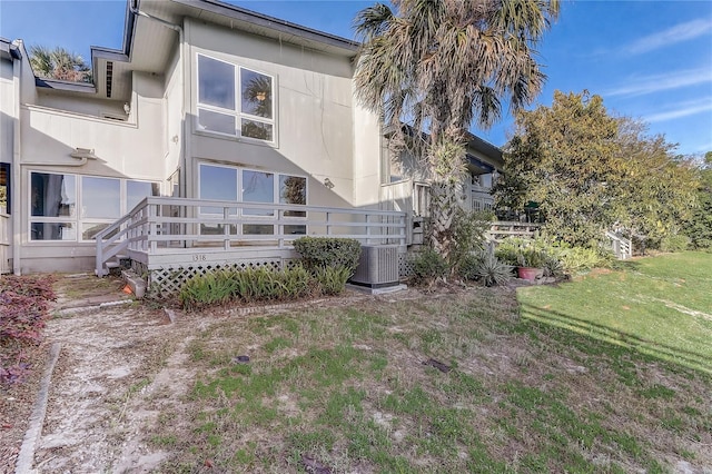 1318 Chebon Ct Unit E-F, Unit E-F, Apopka, FL 32712 - exterior space featuring a lawn, central AC, and stucco siding