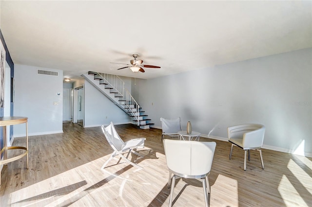 1318 Chebon Ct Unit E-F, Unit E-F, Apopka, FL 32712 - sitting room featuring wood finished floors, stairs, ceiling fan, baseboards, and visible vents