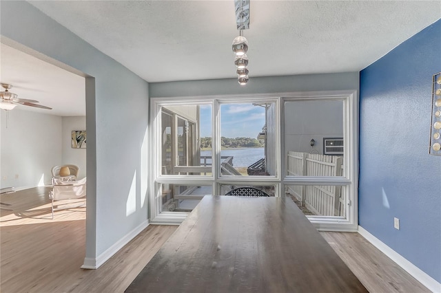 1318 Chebon Ct Unit E-F, Unit E-F, Apopka, FL 32712 - dining area featuring baseboards, wood finished floors, and a water view