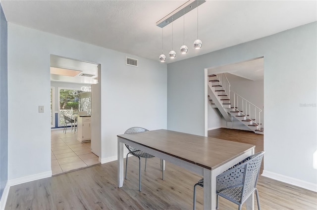 1318 Chebon Ct Unit E-F, Unit E-F, Apopka, FL 32712 - dining space with stairway, visible vents, wood finished floors, and baseboards