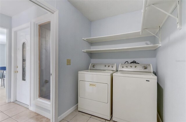 1318 Chebon Ct Unit E-F, Unit E-F, Apopka, FL 32712 - laundry room featuring washer and clothes dryer, baseboards, light tile patterned floors, and laundry area