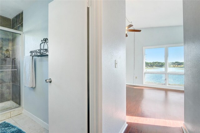1318 Chebon Ct Unit E-F, Unit E-F, Apopka, FL 32712 - bathroom with a shower stall, a water view, baseboards, wood finished floors, and a ceiling fan
