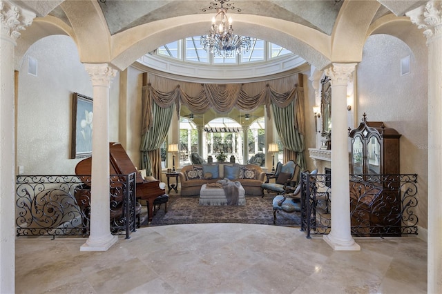 living room with a high ceiling, decorative columns, visible vents, and arched walkways