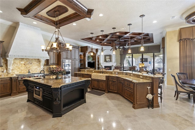 kitchen with a large island, a sink, coffered ceiling, decorative backsplash, and custom exhaust hood