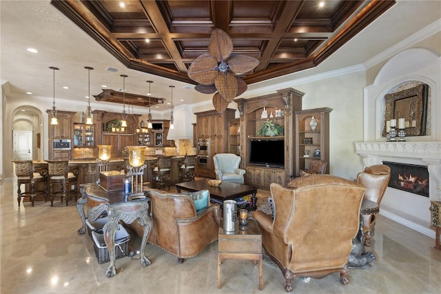 living room featuring ornamental molding, coffered ceiling, recessed lighting, arched walkways, and a lit fireplace