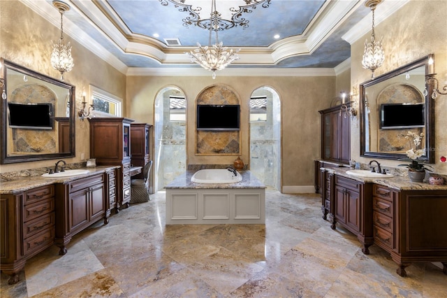 bathroom with a chandelier, two vanities, and a sink