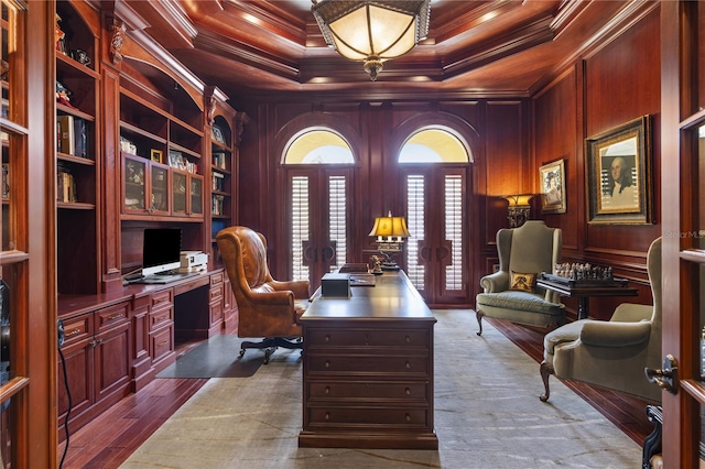 home office featuring dark wood-style flooring, french doors, wooden walls, and ornamental molding