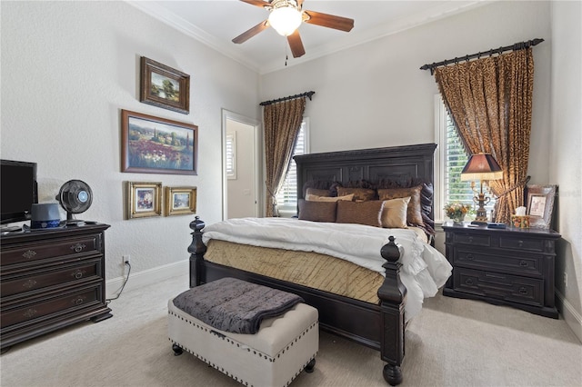 bedroom featuring carpet flooring, baseboards, ceiling fan, and crown molding