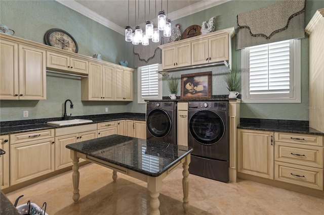 laundry room with cabinet space, independent washer and dryer, crown molding, and a sink