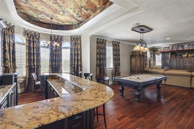 recreation room with a raised ceiling, dark wood-style floors, visible vents, and a healthy amount of sunlight