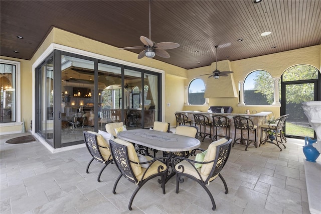 view of patio / terrace featuring outdoor dining space, exterior kitchen, and ceiling fan