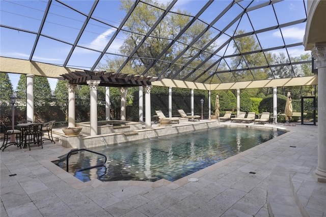 outdoor pool with a patio, an in ground hot tub, and a lanai