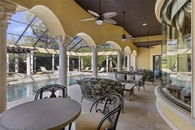 view of patio with glass enclosure, outdoor dining area, an outdoor pool, and an outdoor hangout area