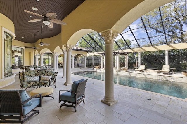 outdoor pool featuring a lanai, ceiling fan, a jacuzzi, and a patio