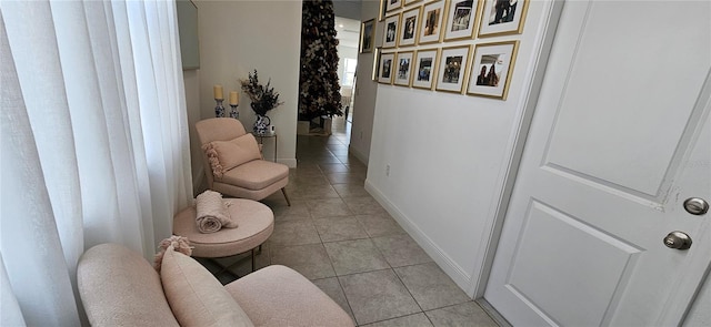 hallway featuring light tile patterned floors and baseboards