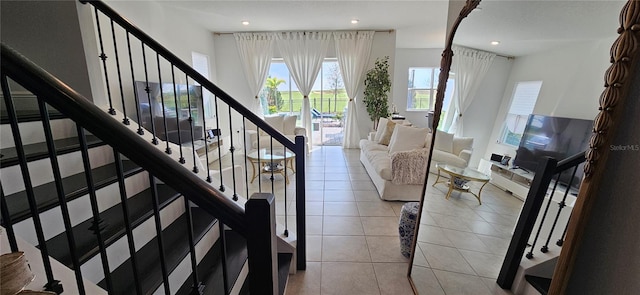 unfurnished living room featuring tile patterned floors, recessed lighting, and stairs