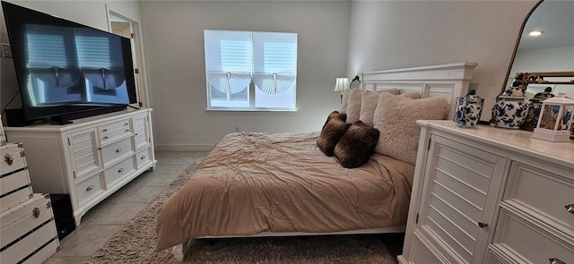 bedroom with baseboards and light tile patterned flooring