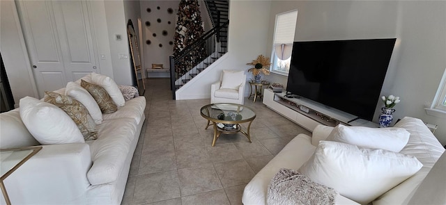 tiled living area featuring stairway