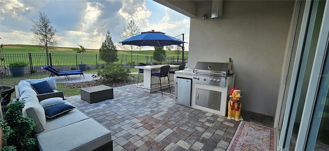 view of patio featuring an outdoor hangout area, area for grilling, a fenced backyard, and a grill