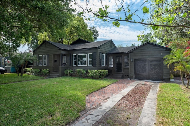 ranch-style home featuring a garage, concrete driveway, and a front yard