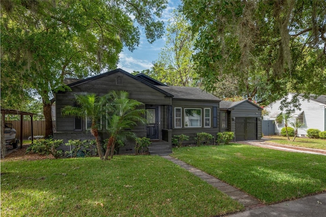 bungalow-style home featuring driveway, an attached garage, a front yard, and fence