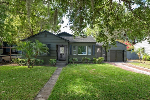 view of front facade with a garage, driveway, and a front lawn