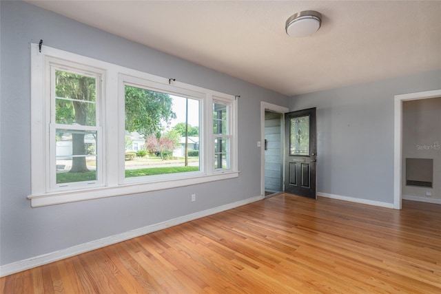 foyer featuring baseboards and light wood-style floors