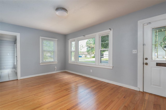 foyer with baseboards and light wood finished floors