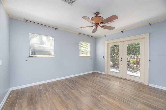 unfurnished room with visible vents, french doors, baseboards, and wood finished floors