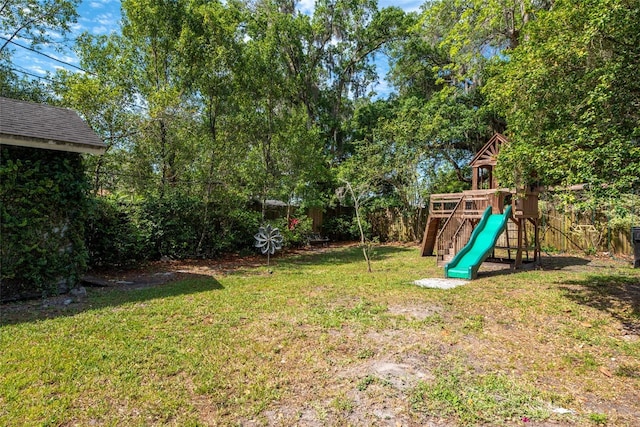 view of yard featuring a playground and a fenced backyard