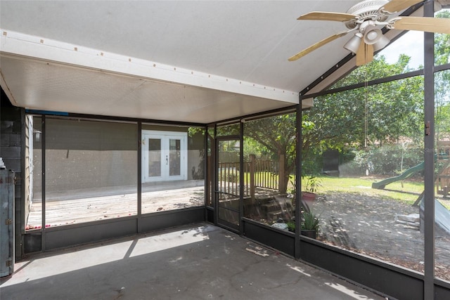 unfurnished sunroom featuring ceiling fan and vaulted ceiling