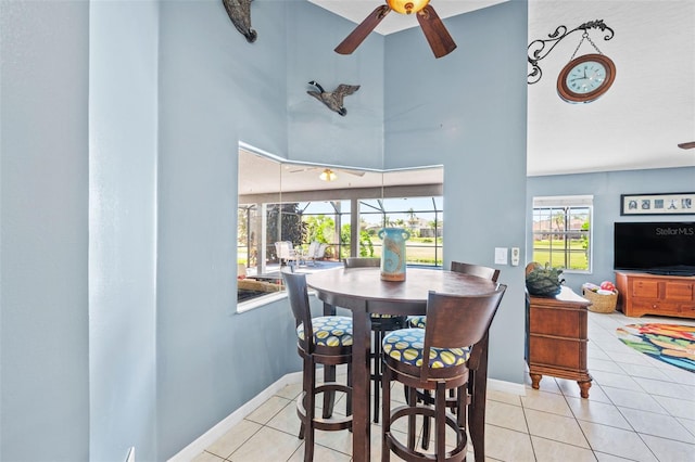 3580 Savannahs Trl, Merritt Island, FL 32953 - dining room featuring tile patterned floors, a towering ceiling, baseboards, and ceiling fan