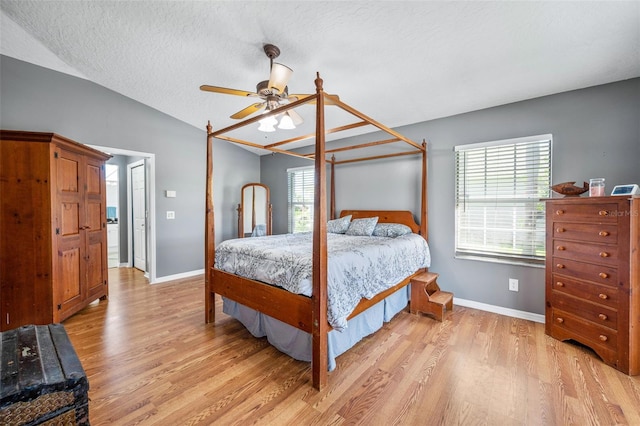 3580 Savannahs Trl, Merritt Island, FL 32953 - bedroom featuring light wood-style flooring, a textured ceiling, multiple windows, and vaulted ceiling